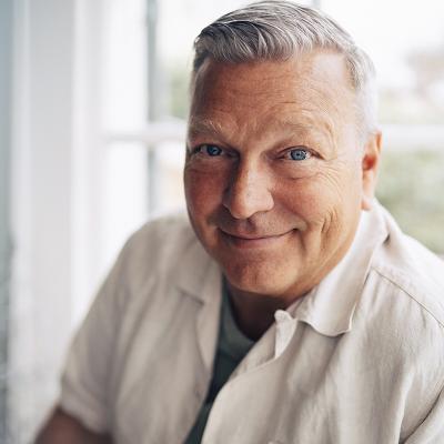 A smiling man looking at the camera